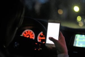 Person driving while looking at phone