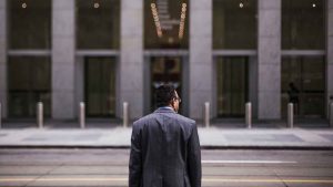Man in suit standing in front of office building